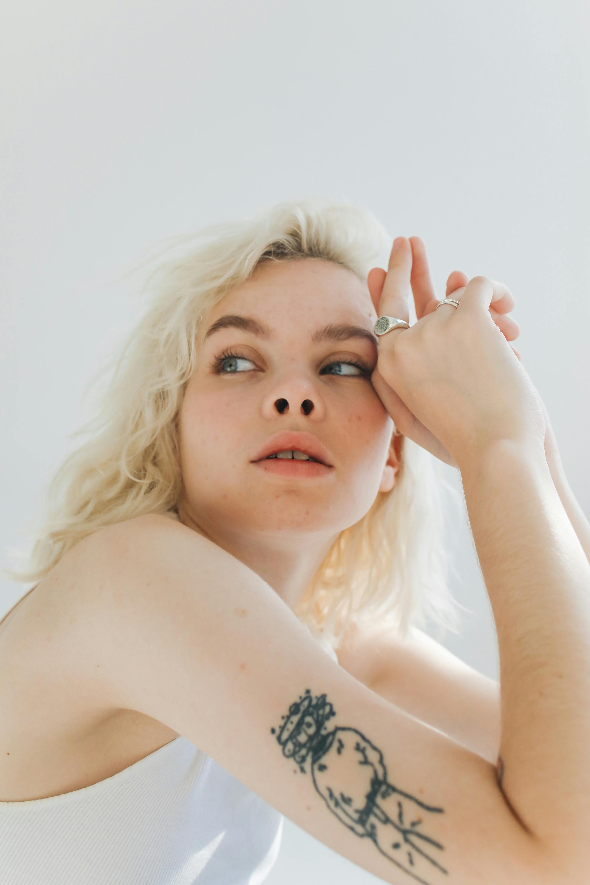 Heart outline tattoo behind ear